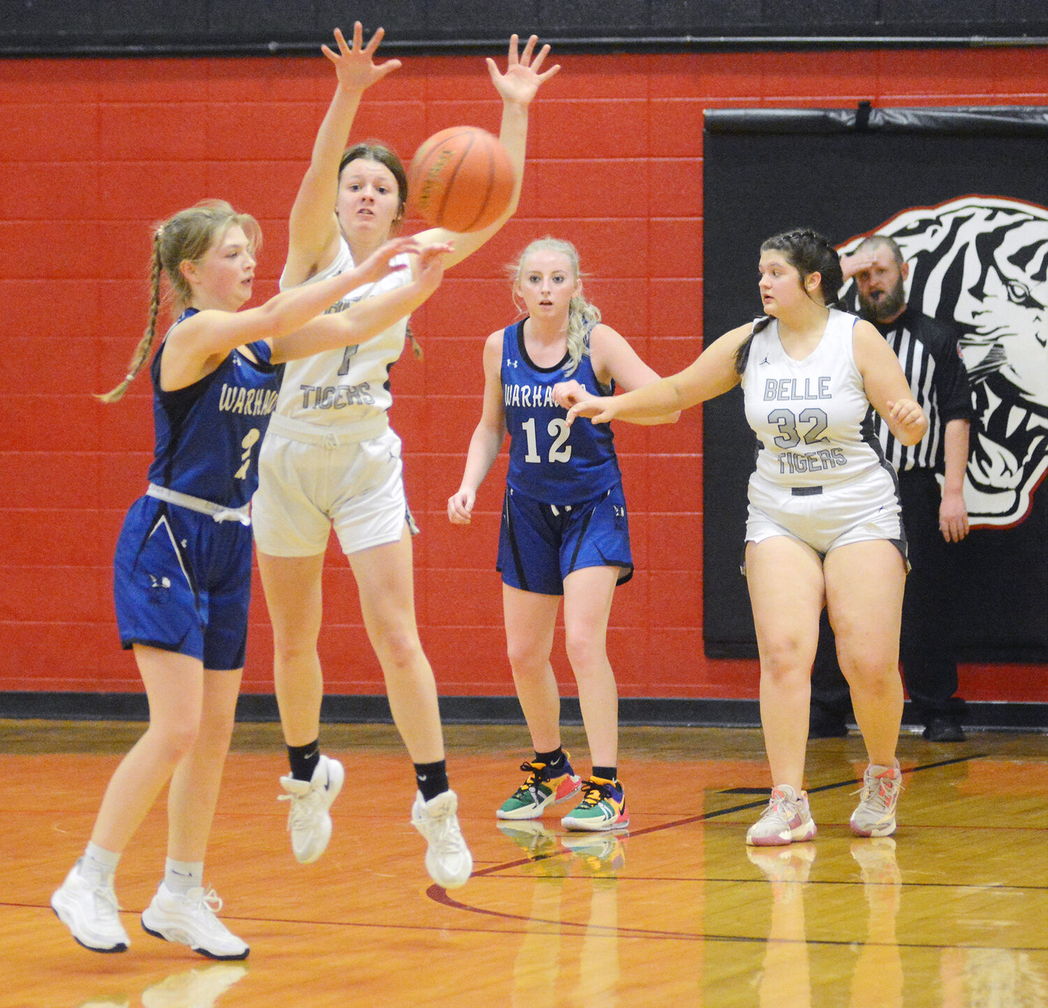 Victoria Busch (second from left) looks to break up a pass during Gasconade Valley Conference (GVC) basketball action last Tuesday night at Belle High School against Bourbon’s Lady Warhawks.